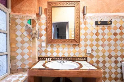 a bathroom with a sink and a mirror at Riad Laila in Marrakech