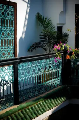 a fence with some flowers on top of it at Riad Ben Tachfine in Marrakech