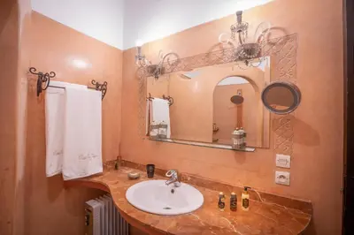 a bathroom with a sink and a mirror at Riad Ben Tachfine in Marrakech