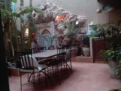 a dining room with a table and chairs at Riad Dar Mchicha in Marrakech