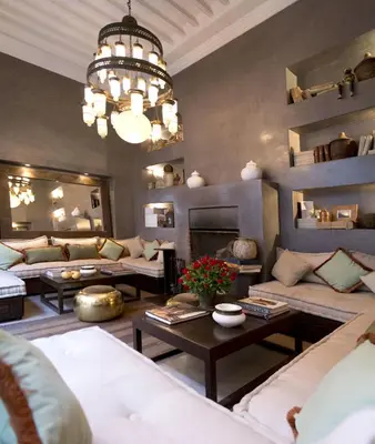 a living room with couches and a chandelier at Riad Abracadabra in Marrakech