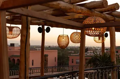 a balcony with chandeliers and a view of the city at Nobu Hotel Marrakech in Marrakech