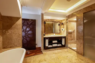 a bathroom with a tub and a sink and a shower at Nobu Hotel Marrakech in Marrakech