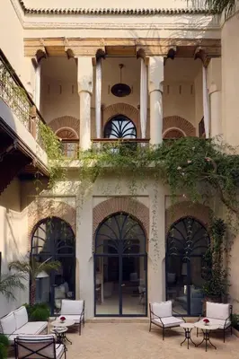 a building with chairs and tables in a courtyard at Nobu Hotel Marrakech in Marrakech