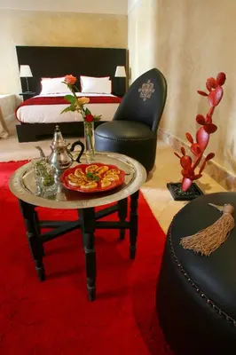 a room with a table with a pizza on it at Riad Dar Asam in Marrakech