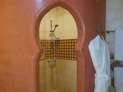 a bathroom with a shower with a shower curtain at Riad Soundouss in Marrakech