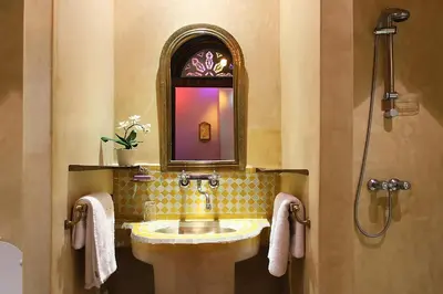 a bathroom with a sink and a mirror at Riad Soundouss in Marrakech