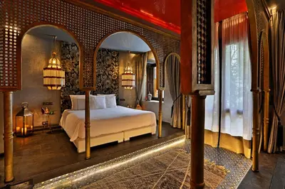 a bedroom with a bed in a room with an archway at Dar Kandi in Marrakech