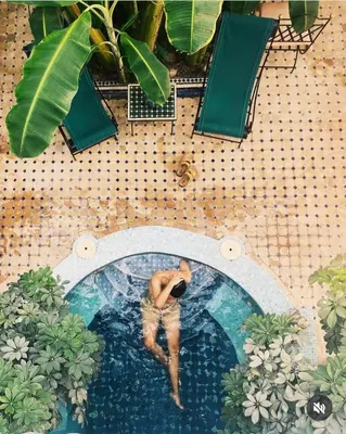 a man in a swimming pool in the middle at Riad Aloes & Spa in Marrakech