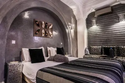 a bedroom with a large bed in a room at Riad Mazaya in Marrakech