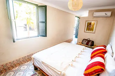 a bedroom with a bed and a window at Riad Makila in Marrakech