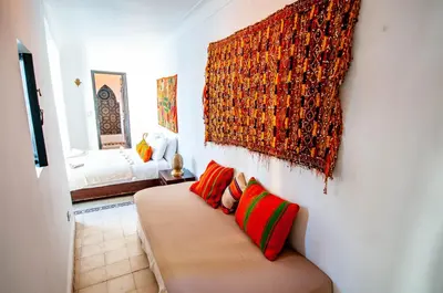 a living room with a couch and a painting on the wall at Riad Makila in Marrakech