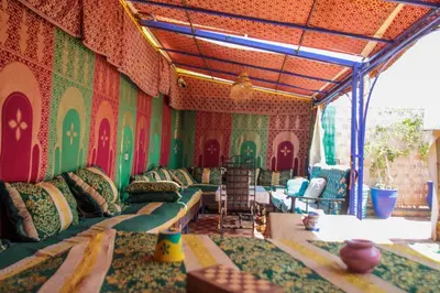 a room with green and red walls with couches and chairs at For You Riad Marrakech in Marrakech