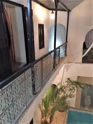 a balcony with a fence and a swimming pool at Riad SASHA in Marrakech