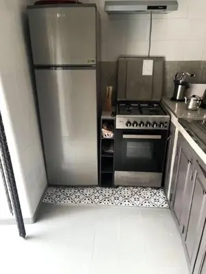a kitchen with a stainless steel refrigerator and a stove at Riad SASHA in Marrakech