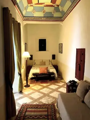 a bedroom with a bed and a ceiling at Riad SASHA in Marrakech
