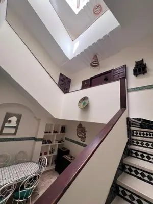 a staircase in a house with a skylight at Dar Tariq 3 suites avec pisicine in Marrakech