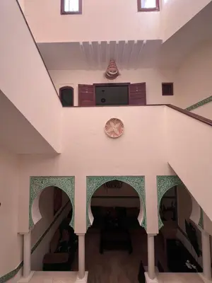 a staircase in a house with a stair case at Dar Tariq 3 suites avec pisicine in Marrakech