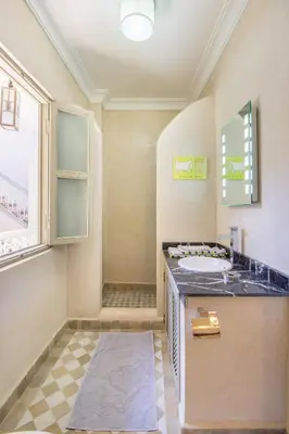 a bathroom with a sink and a counter top at Riad Privé De Luxe Au Coeur De La Kasbah Avec Hammam in Marrakech