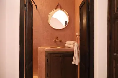 a bathroom with a sink and a mirror at Riad l'Oiseau du Paradis in Marrakech