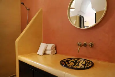 a bathroom counter with a mirror and a sink at Riad l'Oiseau du Paradis in Marrakech