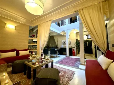a living room with a couch and a table at Riad ART DE VIVRE avec Jacuzzi in Marrakech