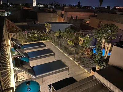 an overhead view of a balcony with lounge chairs at Riad ART DE VIVRE avec Jacuzzi in Marrakech