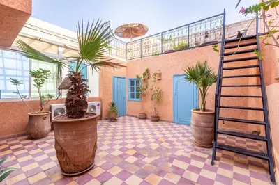 a room with potted plants and a staircase in it at Exclusive private Riad in Marrakech
