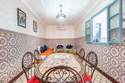 a dining room with a table and chairs at Exclusive private Riad in Marrakech