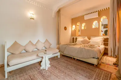 a bedroom with a bed and a couch at RIAD AWINATI Location Privatisée ,piscine chauffée , beau Rooftop in Marrakech