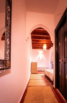 a bedroom with a bed and a hallway with a door at Riad ViewPoint in Marrakech