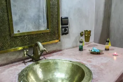 a sink in a bathroom with a mirror at Riad Minorisa in Marrakech