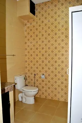 a bathroom with a white toilet in a room at Résidence Miramare Marrakech in Marrakech