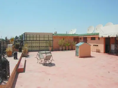 a patio with chairs and a table and a building at Résidence Miramare Marrakech in Marrakech