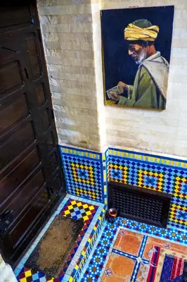 a room with a painting of a man on the wall at Riad 58 Blu in Marrakech