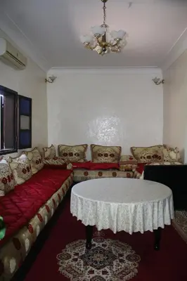 a living room with a table and a couch at Rue Riad Zitoun el Jdid in Marrakech