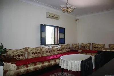 a living room with a couch and a table at Rue Riad Zitoun el Jdid in Marrakech
