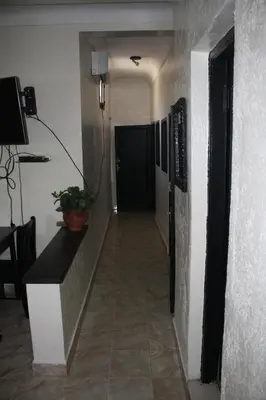 a hallway leading to a room with a door and a table at Rue Riad Zitoun el Jdid in Marrakech