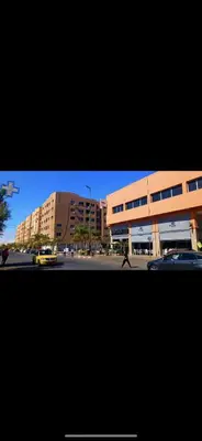 a picture of a building and a street with cars at Studio au centre wifi Clim in Marrakech