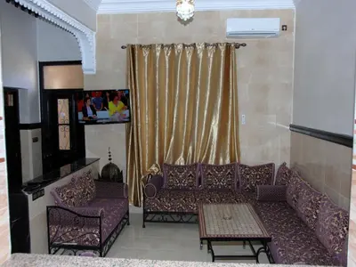a living room with a couch and a table at Appartements Ziad Guéliz in Marrakech