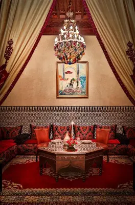 a living room with a couch and a chandelier at Riad Kniza in Marrakech