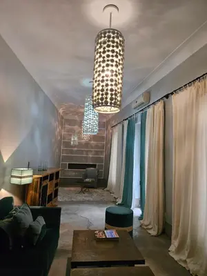 a living room with a couch and a table at Riad First in Marrakech