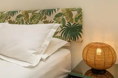a bed with a pillow and a lamp next to it at Riad D'ari in Marrakech