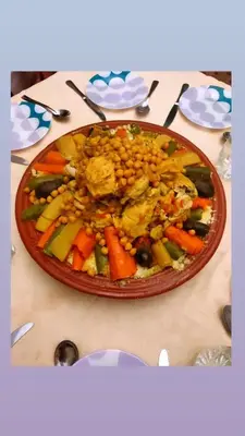 a plate of food with beans and vegetables on a table at Riad Zahra Marrakech Piscine in Marrakech