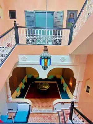 an overhead view of a staircase with a chandelier at Riad Zahra Marrakech Piscine in Marrakech