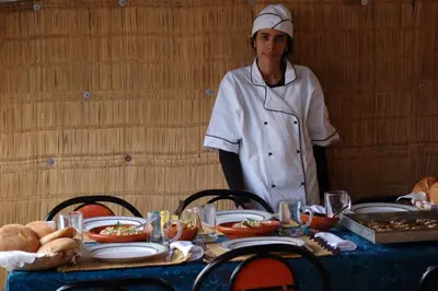 a chef standing in front of a table with food at Dar Margot Marrakech in Marrakech