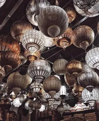 a bunch of chinese paper lanterns hanging from a ceiling at Riad SHIRAZ in Marrakech