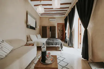 a living room with a couch and a bed at Dar Nour el Houda in Marrakech