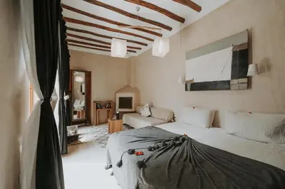 a bedroom with a bed and a couch in a room at Dar Nour el Houda in Marrakech