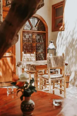a dining room with a table and two chairs at Dar Nour el Houda in Marrakech